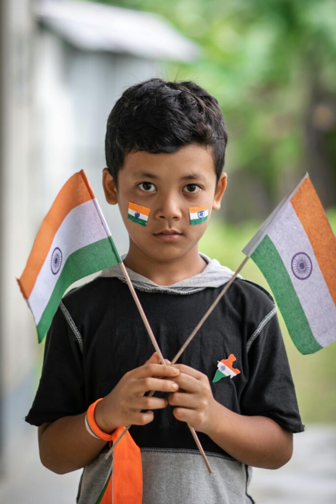 A Boy Holding Two Indian Flags